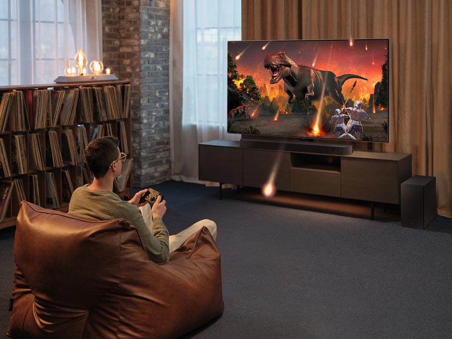 Samsung HW-Q600C установлен под телевизором в гостиной — домашний кинотеатр с объёмным звуком